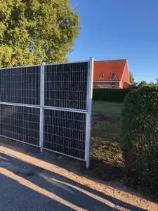 Støjhegn opsat langs vej for effektiv støjreduktion og afskærmning